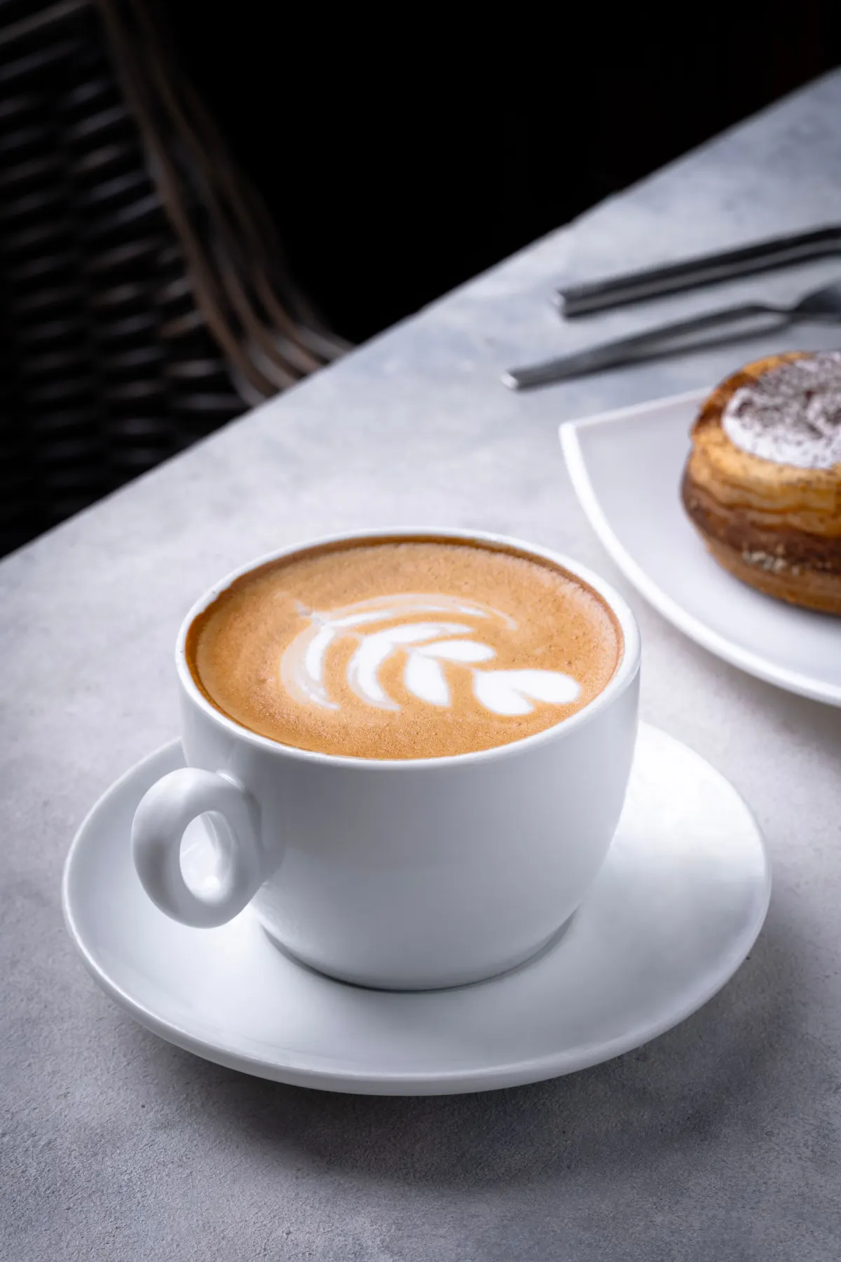 Latte art with a sweet pastry