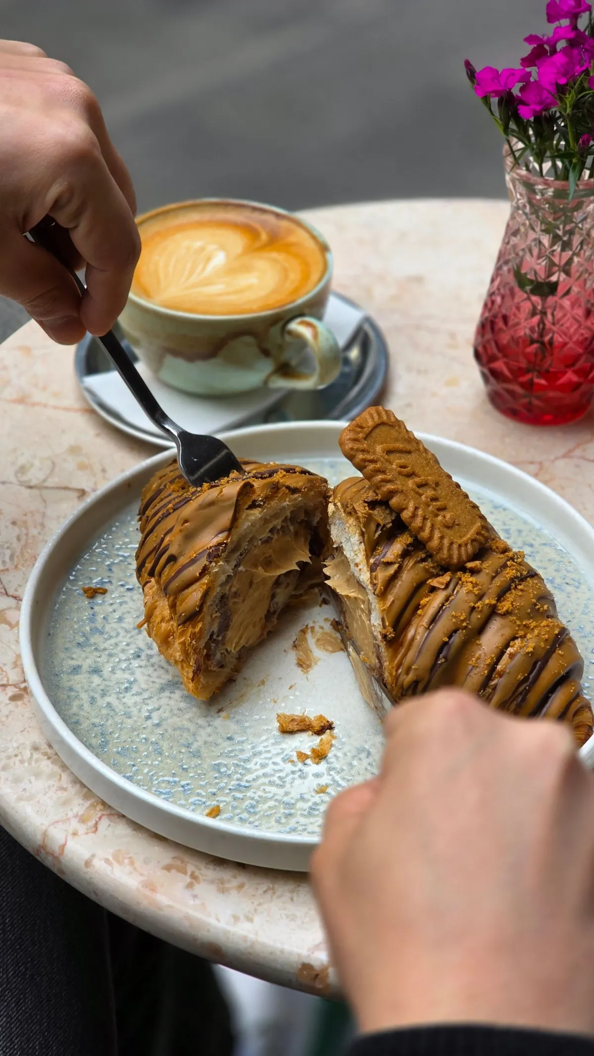 Coffee and a pastry on a cafe table