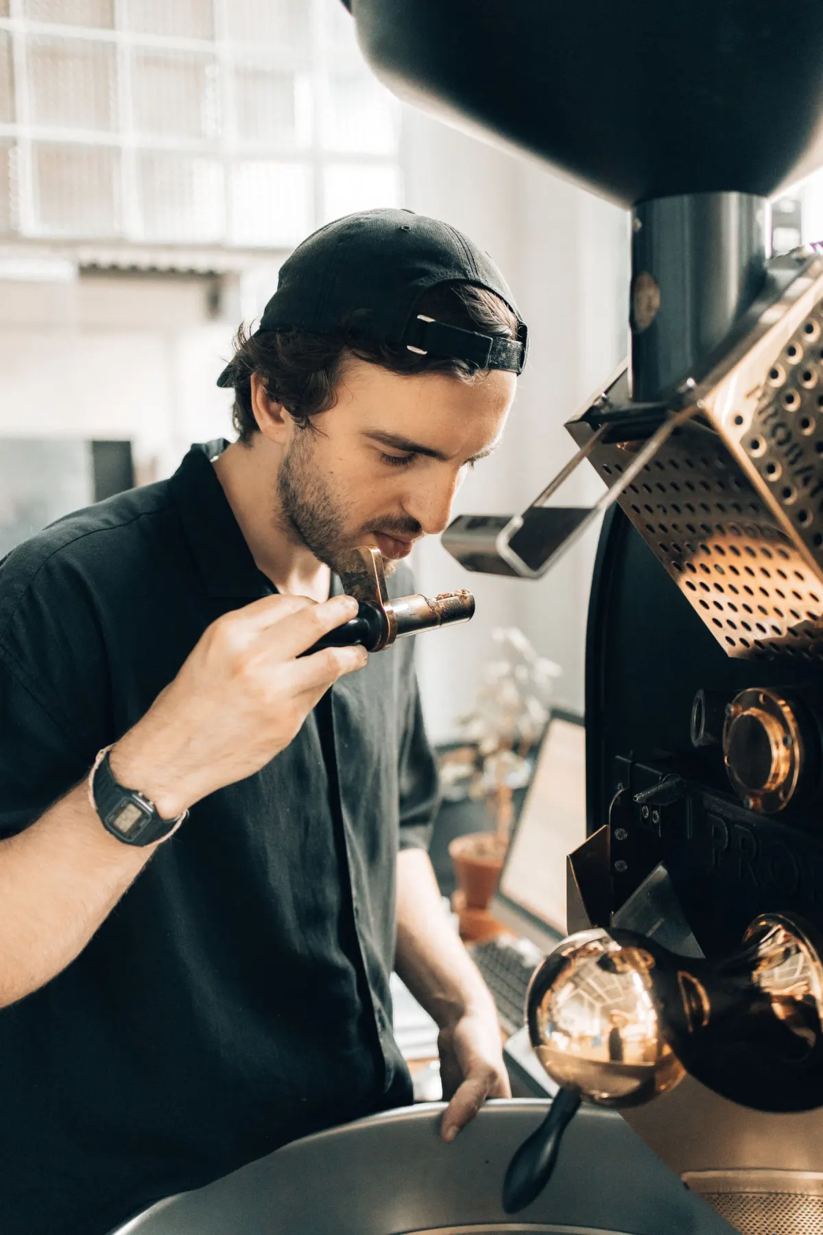 A barista checking freshly roasted coffee